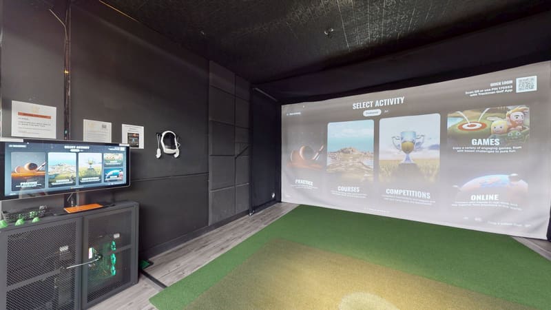 Bay 1 at Club X Indoor Golf showing the TrackMan Practice menu — 16:9 simulator screen, hitting mat, dark walls, Aurora, Ontario