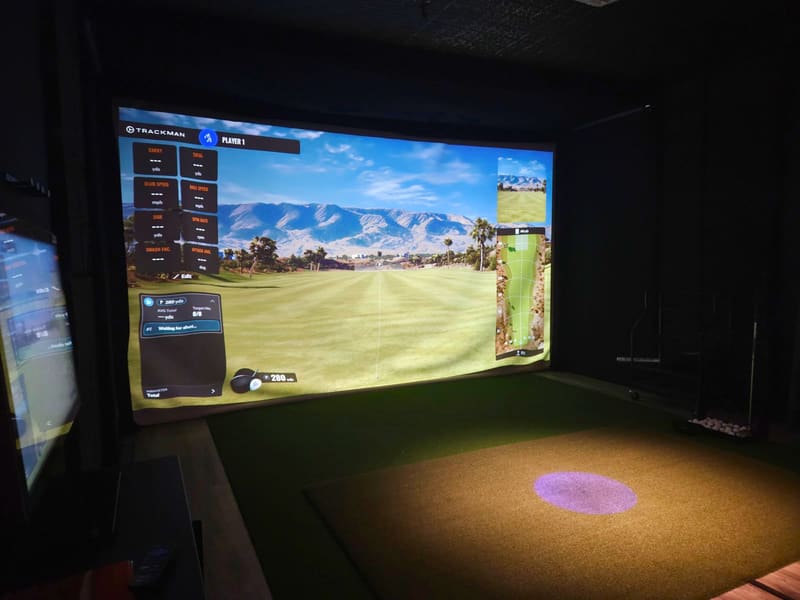 Indoor golf simulator bay at Club X Indoor Golf in Aurora during winter training season