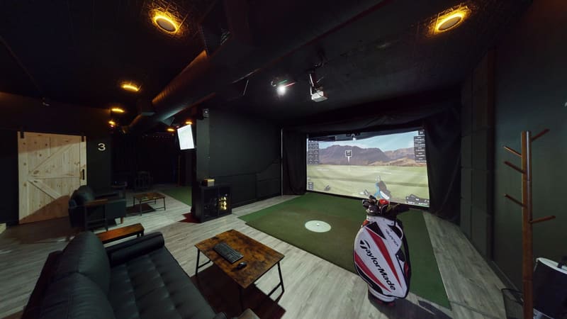 Bay 1 lounge view at Club X Indoor Golf — member space, Aurora